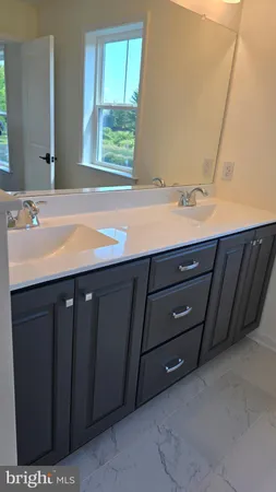a bathroom with a sink vanity and a mirror