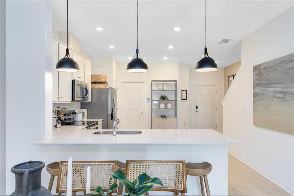 4443 Jetty Lane Palm Bay, FL 32905 - Photo 8 of 32 a kitchen with kitchen island a counter top space a sink stainless steel appliances and cabinets