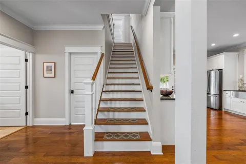 a view of entryway and hall with wooden floor
