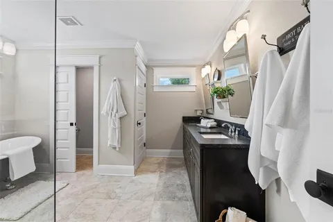 a bathroom with a granite countertop sink a mirror and a shower