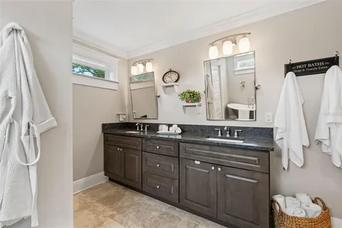 a bathroom with double vanity sinks and a mirror
