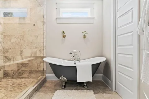 a bathroom with a sink a toilet a shower and a mirror