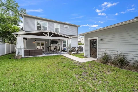 a view of a house with backyard and sitting area