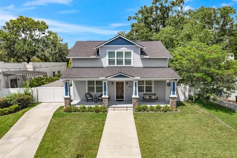a front view of a house with a garden and plants