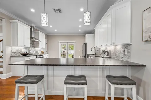 a kitchen with stainless steel appliances granite countertop a sink and cabinets