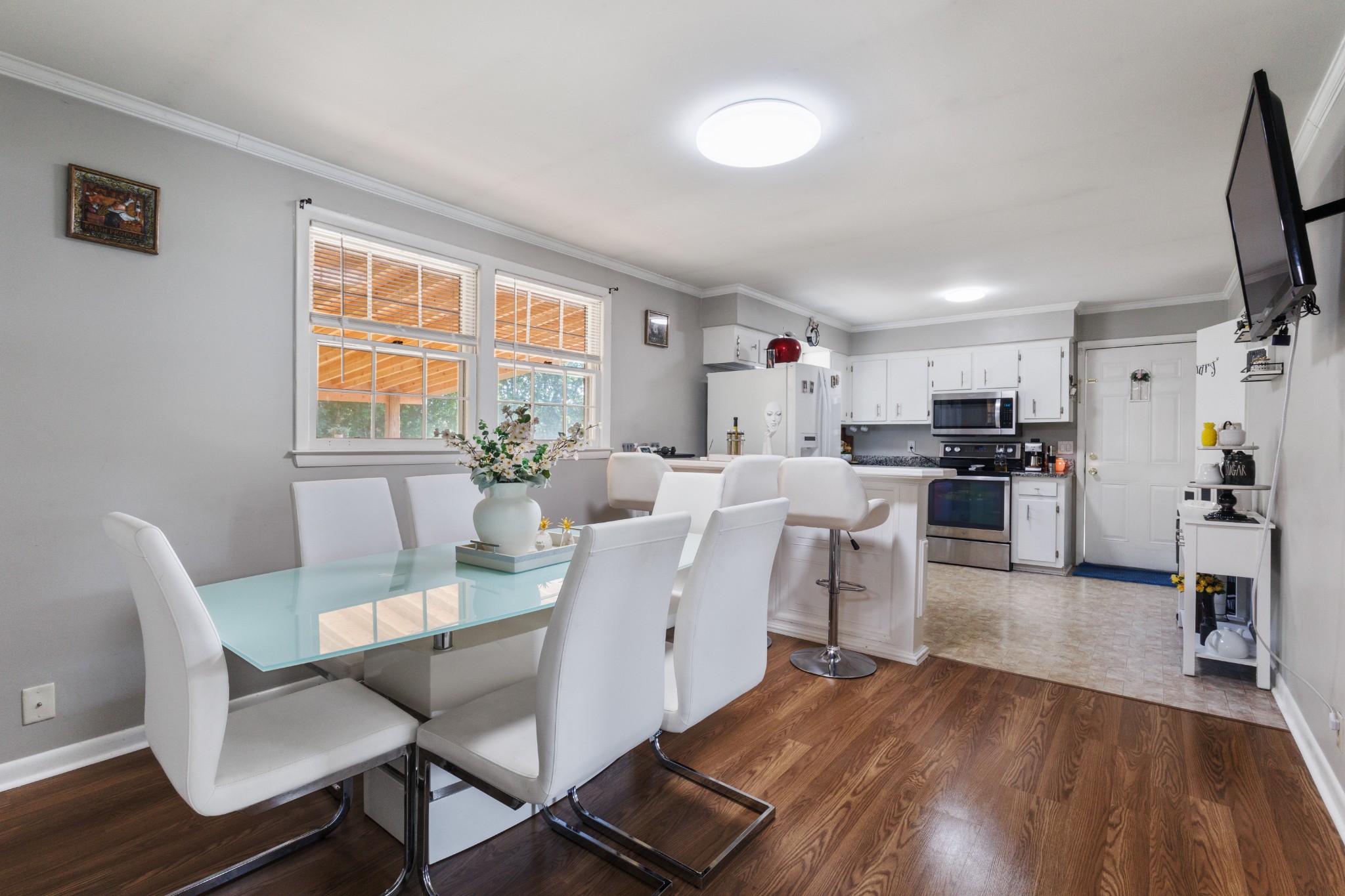 a view of a dining room with furniture and wooden floor