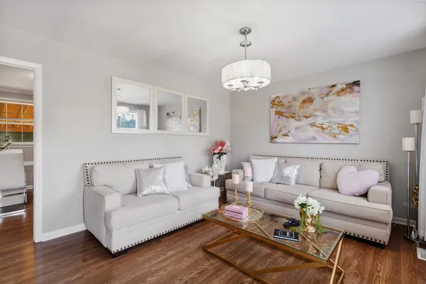 a living room with furniture chandelier and a couch