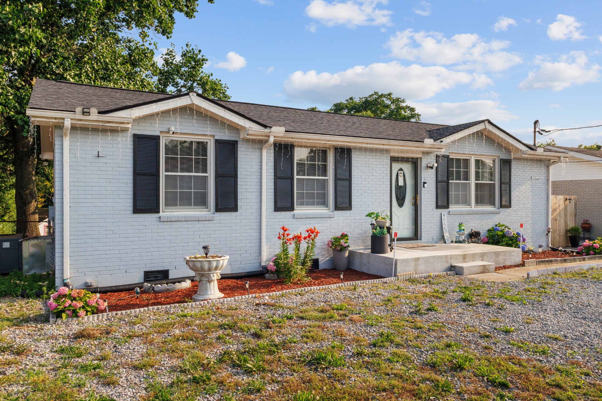 528 Singer Drive Madison, TN 37115 - Photo 3 of 24 a front view of a house with garden