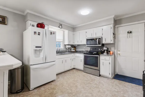 a white refrigerator freezer sitting in a kitchen
