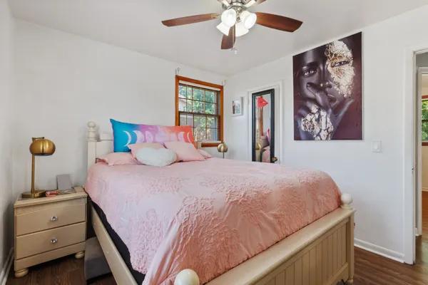 a bedroom with a large bed and a chandelier