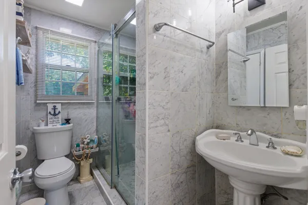 a bathroom with a sink toilet and shower