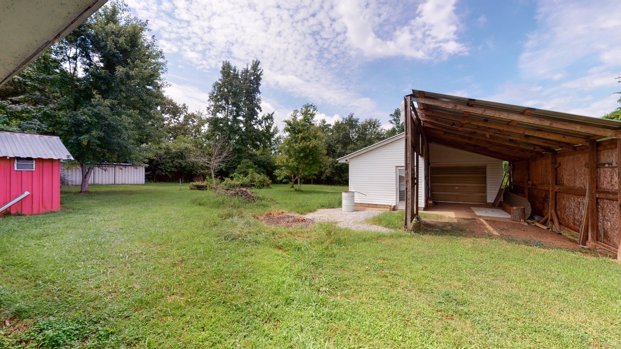 31129 Ardmore Ridge Road Ardmore, TN 38449 - Photo 35 of 50 a view of a backyard with table and chairs and a large tree