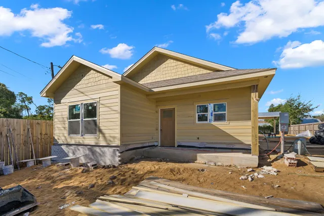 a view of a house with snow on the road