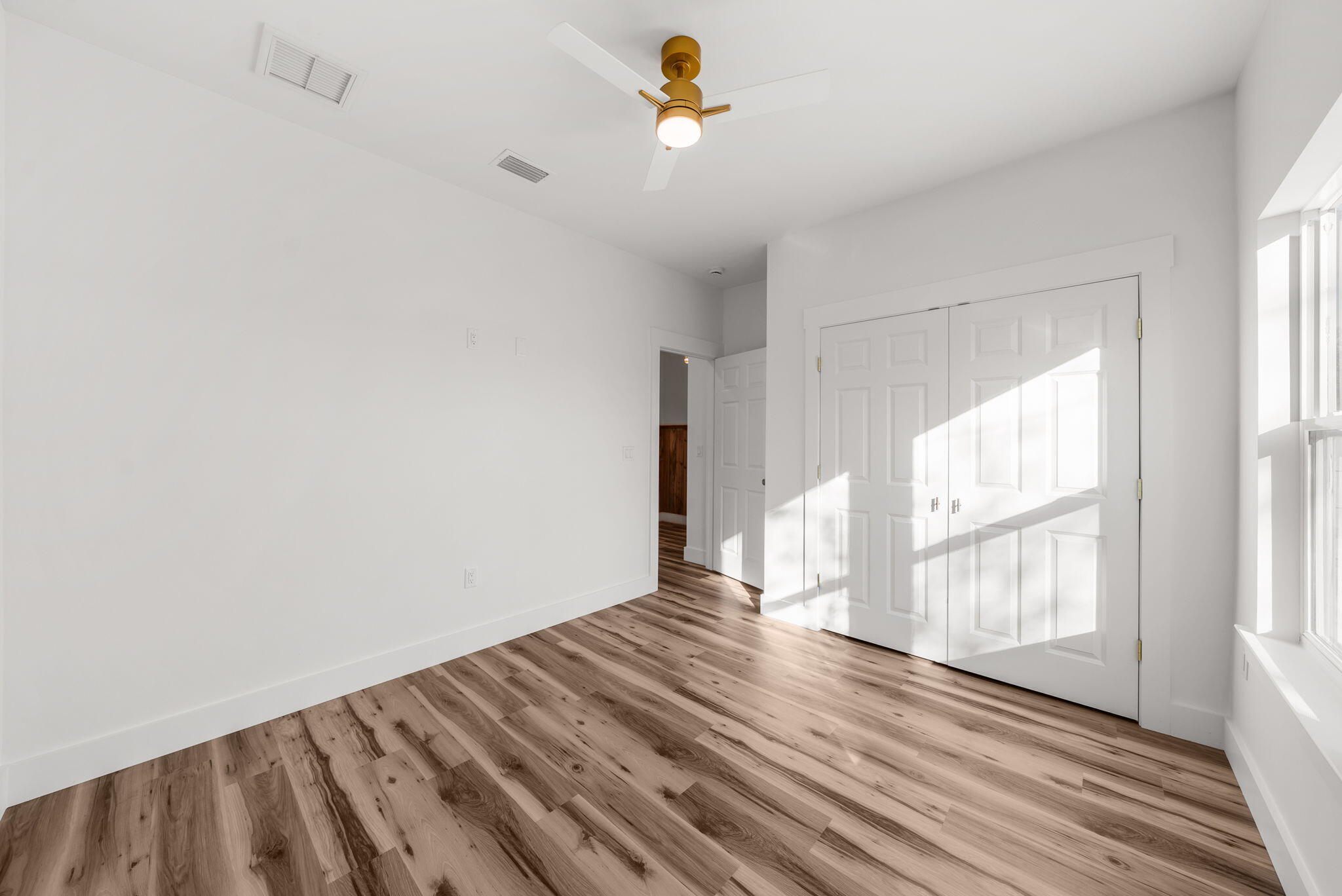 1831 McKenzie Road Southport, FL 32409 - Photo 25 of 48 a view of empty room with wooden floor and fan