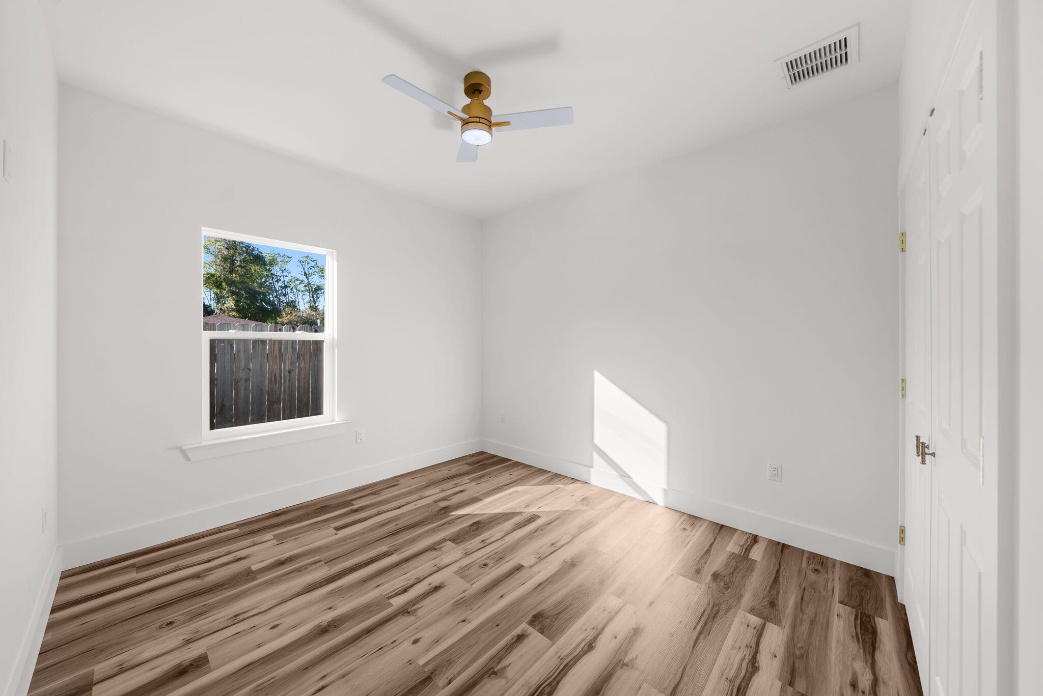 1831 McKenzie Road Southport, FL 32409 - Photo 26 of 48 a view of an empty room with wooden floor and a window