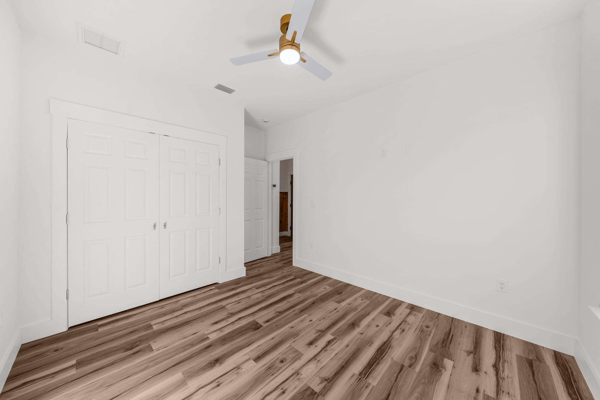 1831 McKenzie Road Southport, FL 32409 - Photo 28 of 48 a view of a room with wooden floor and ceiling fan