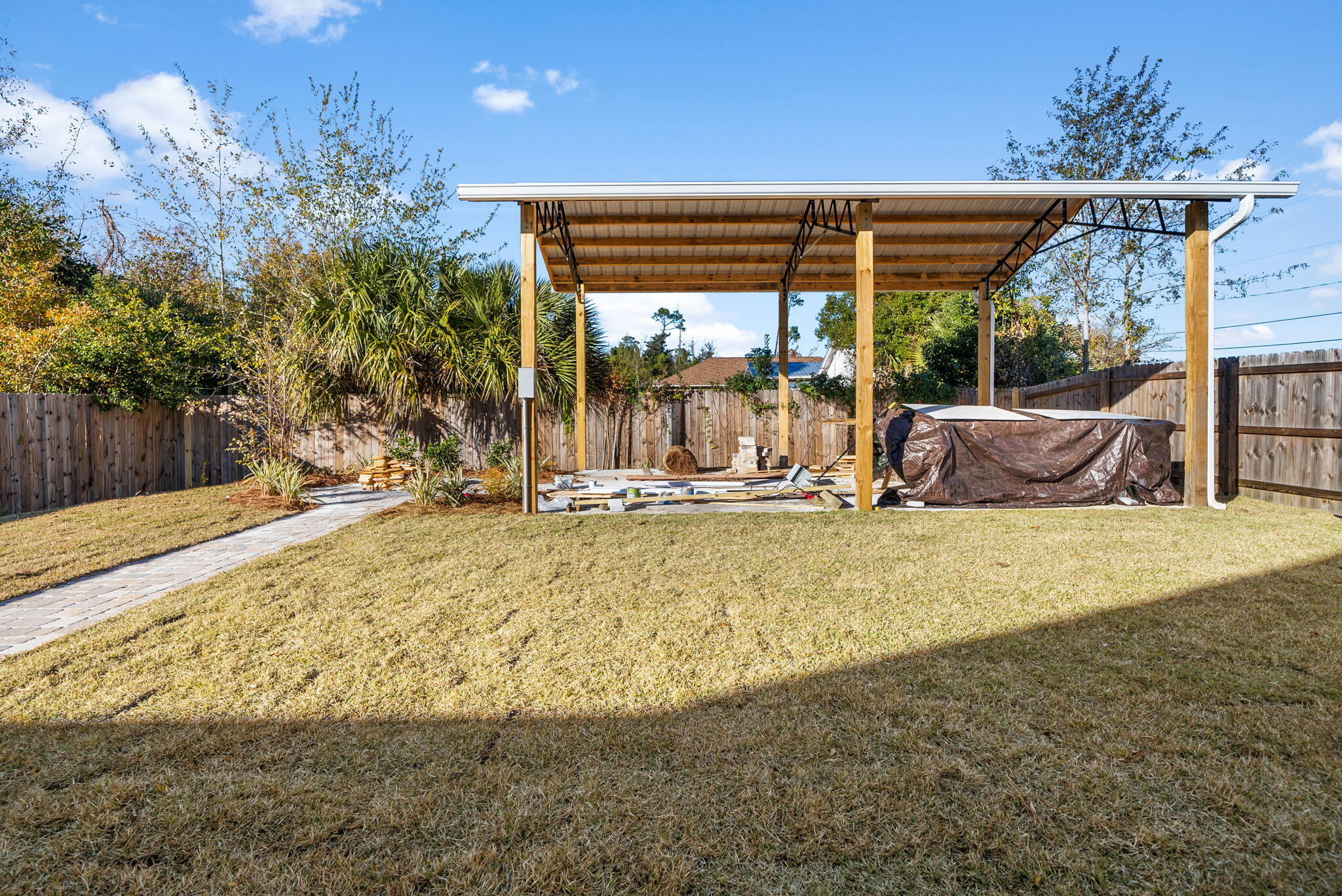 1831 McKenzie Road Southport, FL 32409 - Photo 33 of 48 a view of a patio with a table and chairs and potted plants