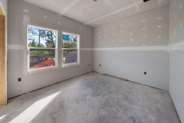 a front view of house with yard outdoor seating and covered with snow