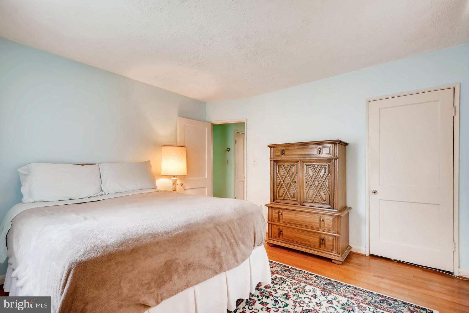 1018 St Albans Road Baltimore, MD 21239 - Photo 6 of 28 a bedroom with a bed and wooden floor