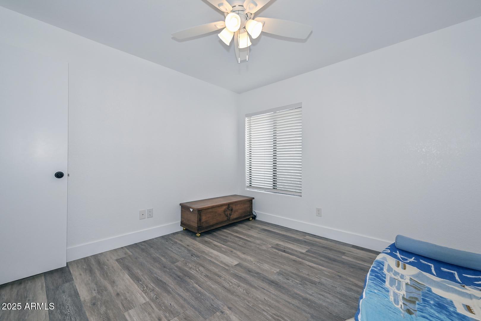 606 West Grandview Road Phoenix, AZ 85023 - Photo 20 of 33 a view of a room with wooden floor and ceiling fan