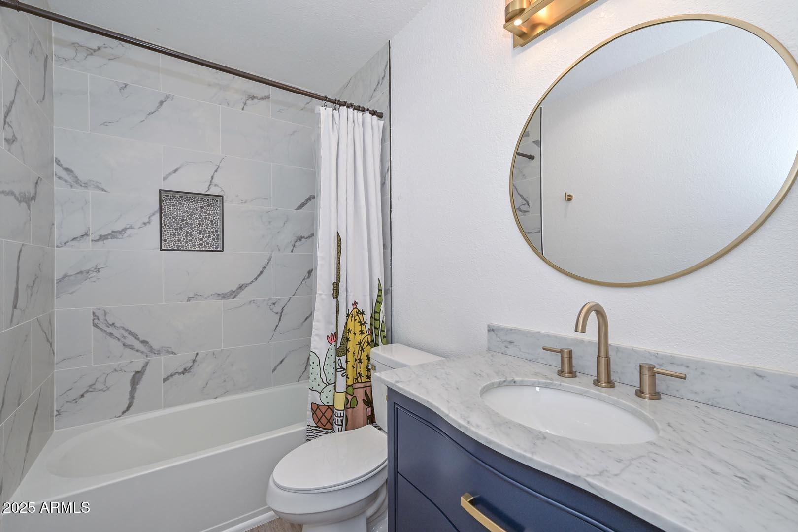 606 West Grandview Road Phoenix, AZ 85023 - Photo 24 of 33 a bathroom with a granite countertop sink a toilet and a mirror