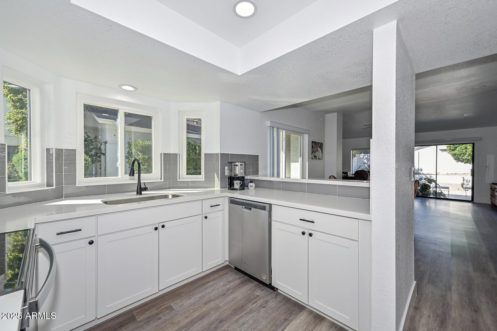 606 West Grandview Road Phoenix, AZ 85023 - Photo 3 of 33 a large white kitchen with a window