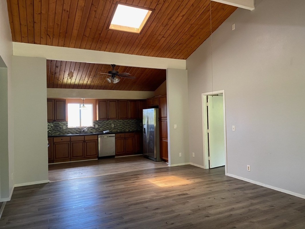 4489 Punee Road Koloa, HI 96756 - Photo 6 of 27 a kitchen with stainless steel appliances granite countertop a stove cabinets and wooden floor