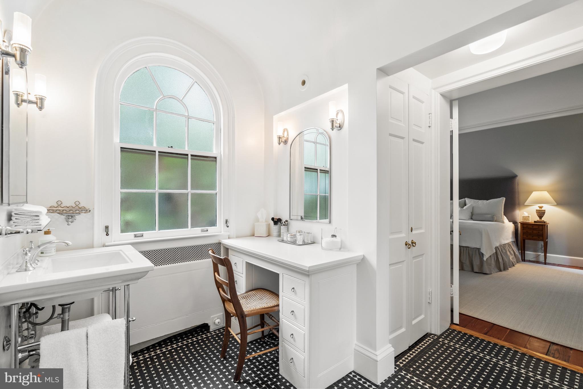 1671 31st Street Northwest Washington, DC 20007 - Photo 13 of 27 a bathroom with a sink a mirror and a window
