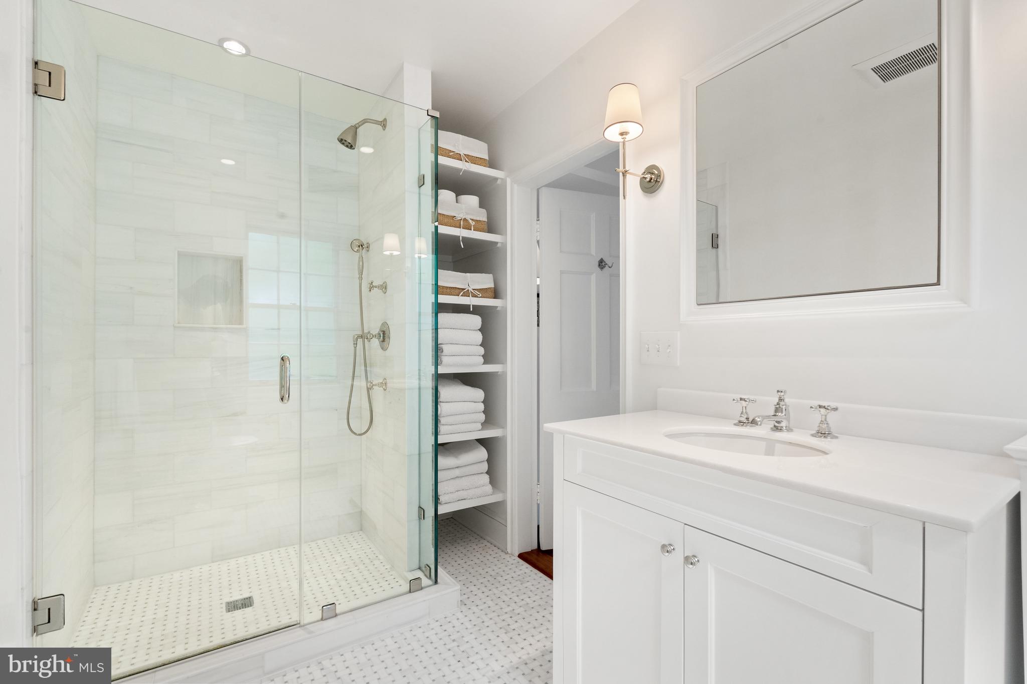 1671 31st Street Northwest Washington, DC 20007 - Photo 19 of 27 a bathroom with a shower sink and mirror