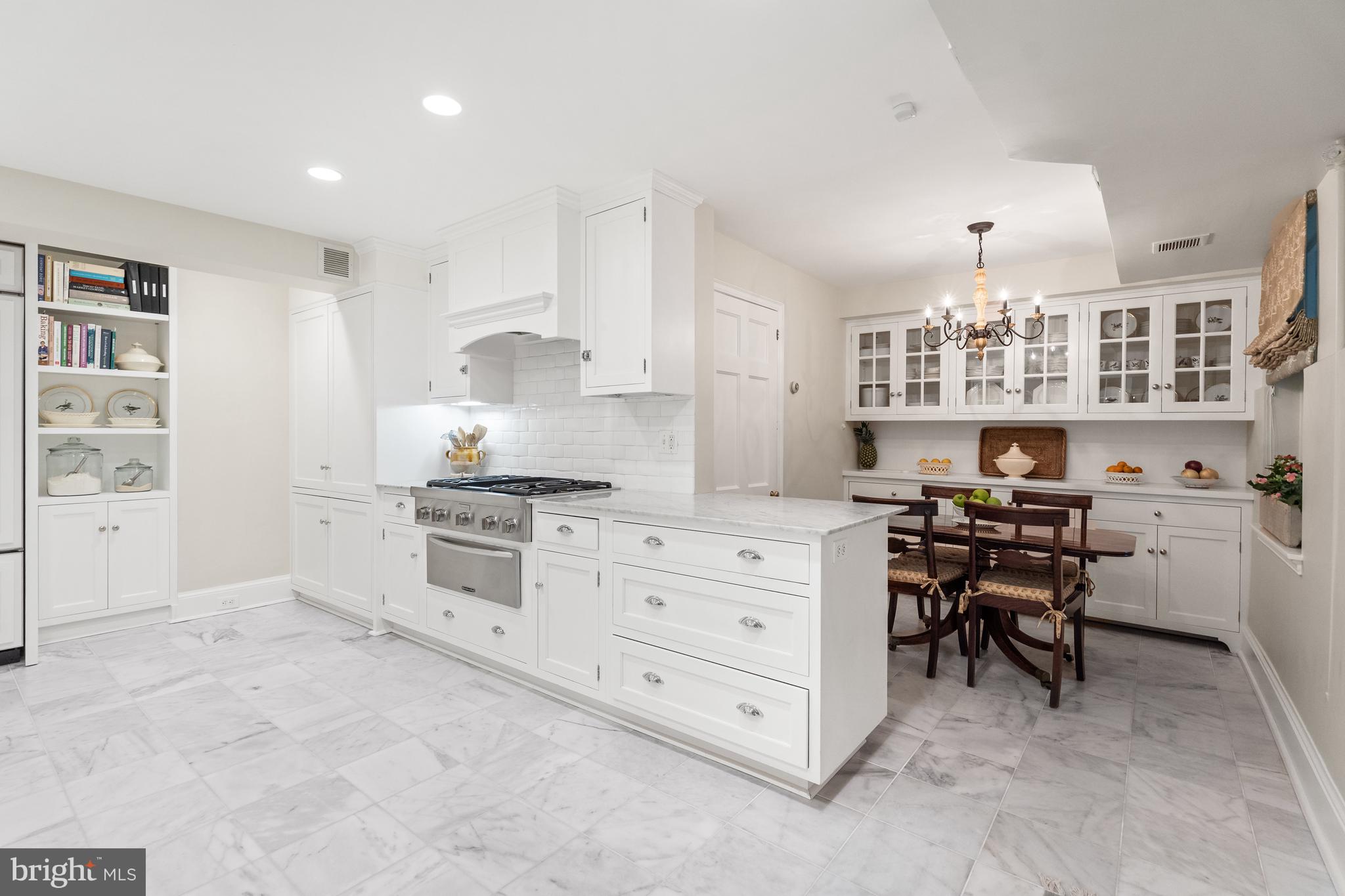 1671 31st Street Northwest Washington, DC 20007 - Photo 20 of 27 a kitchen with cabinets and chairs