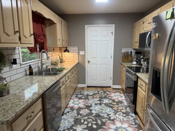 a view of a dining room with furniture and chandelier