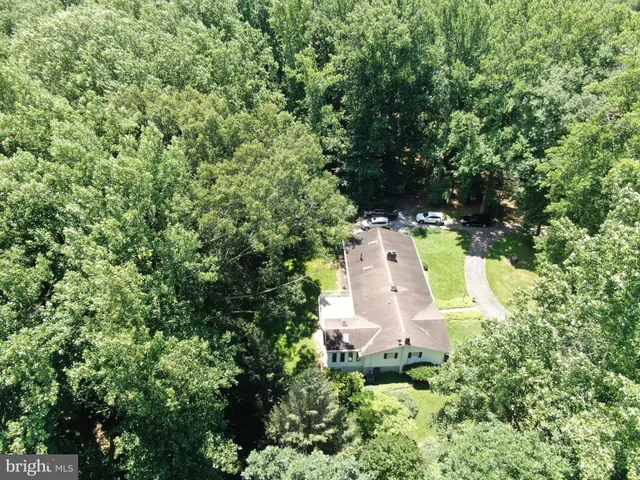 an aerial view of a house with a yard and garden