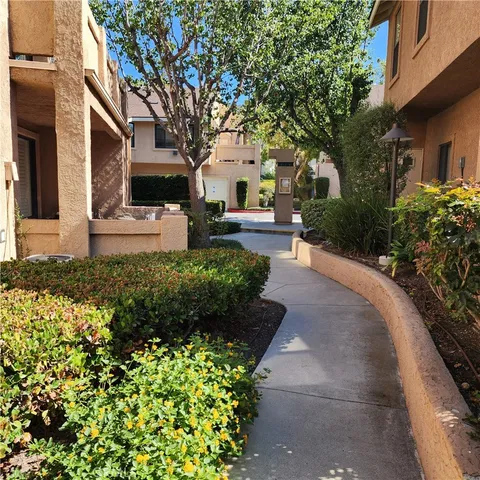 a front view of a house with a yard and garden