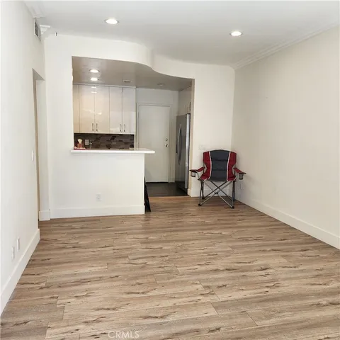 a view of a room with wooden floor and furniture