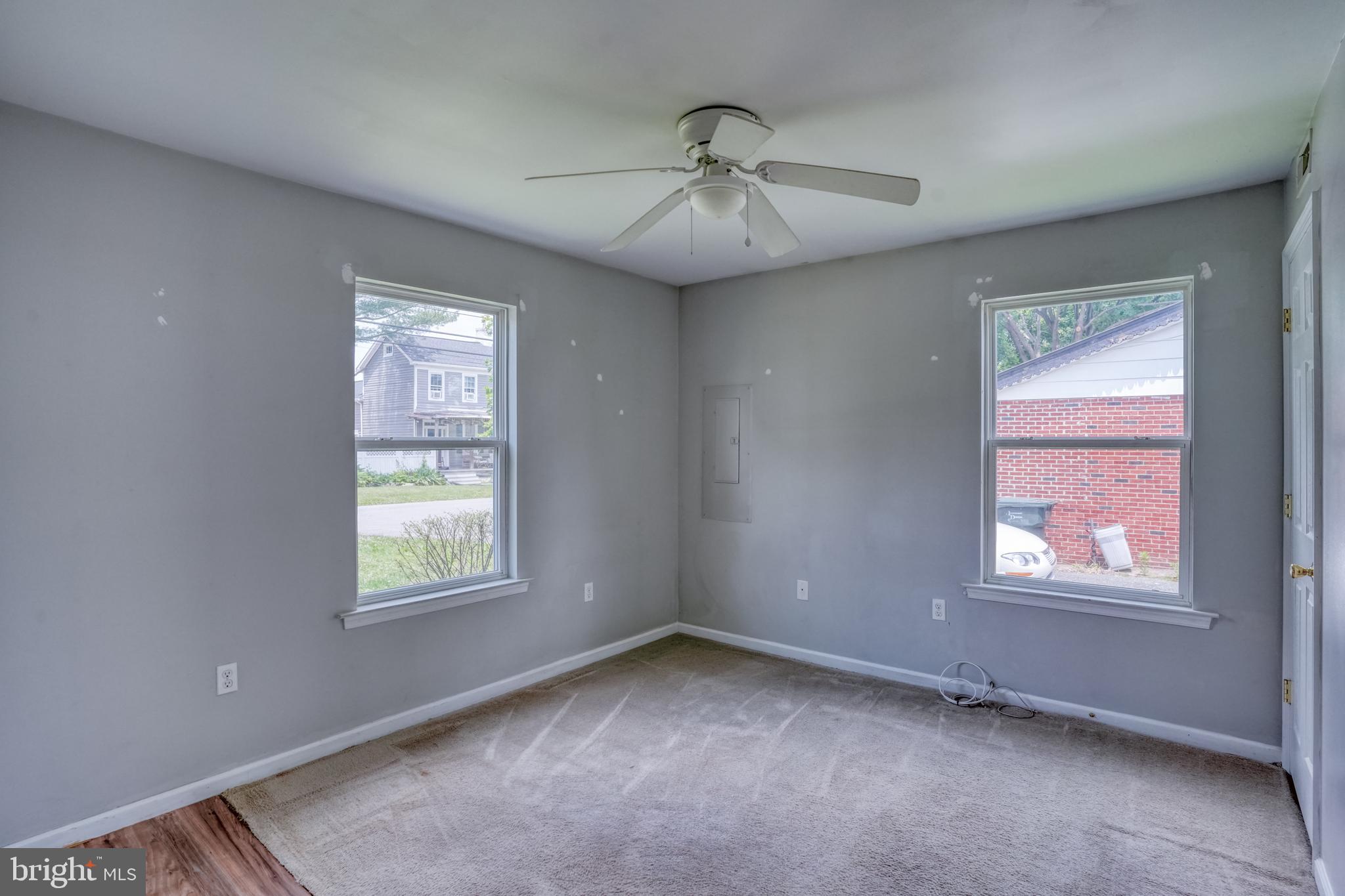 203 Hamilton Street Delaware City, DE 19706 - Photo 12 of 27 an empty room with windows and fan