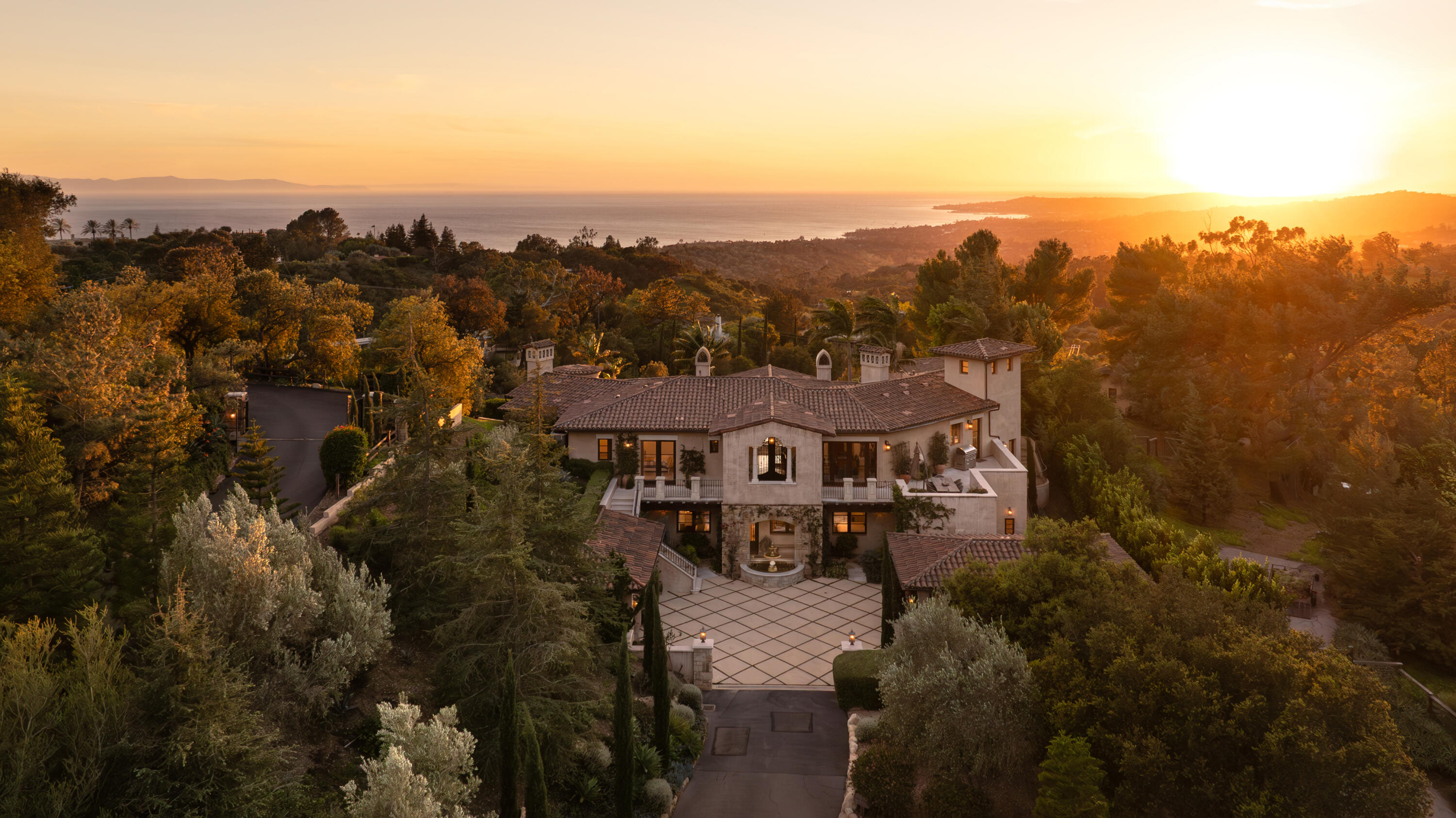 an aerial view of residential houses with outdoor space and trees