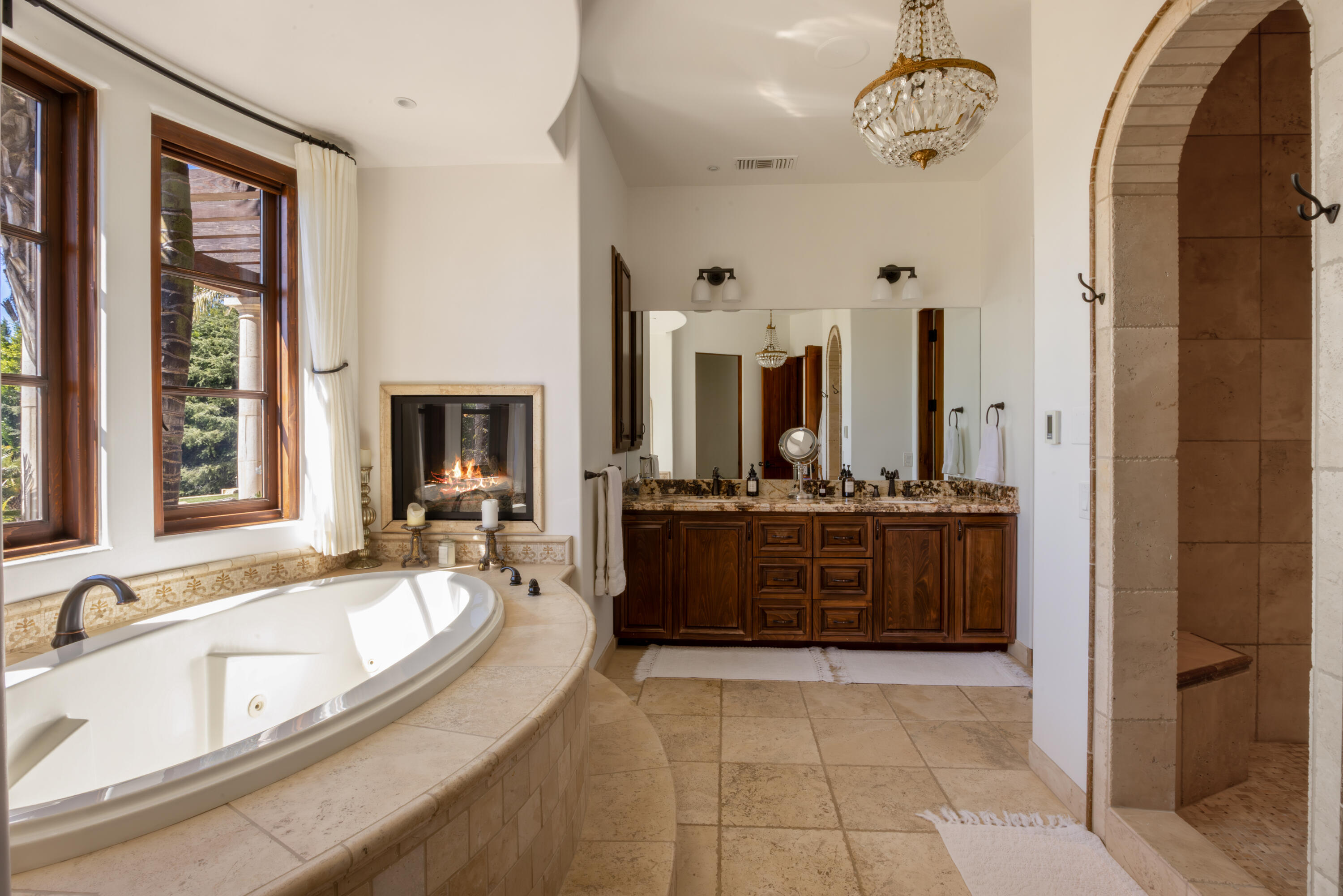3091 Hidden Valley Lane Montecito, CA 93108 - Photo 13 of 62 a large spacious bathroom with a granite countertop tub sink and mirror