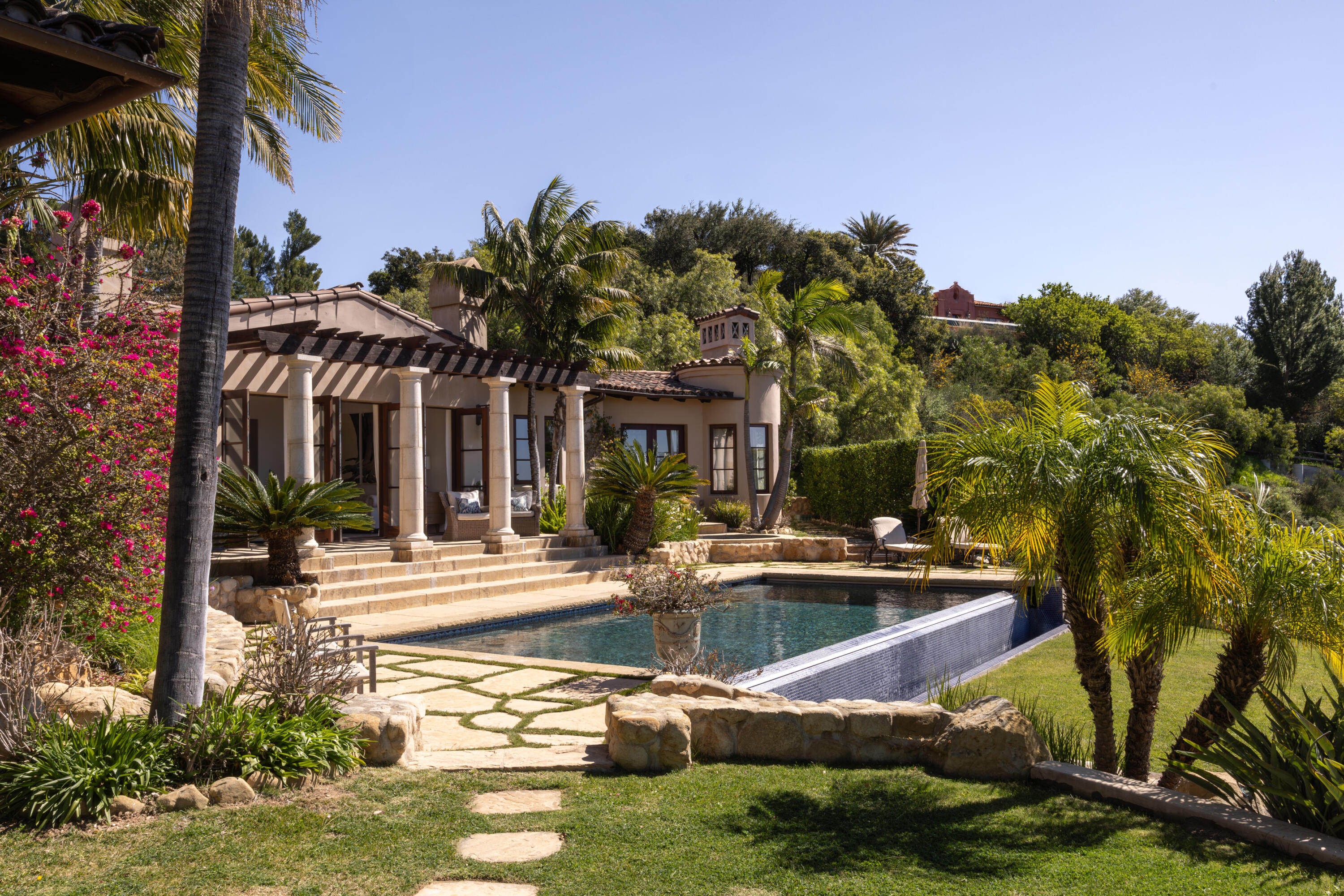 3091 Hidden Valley Lane Montecito, CA 93108 - Photo 22 of 62 a front view of a house with swimming pool and trees in the background