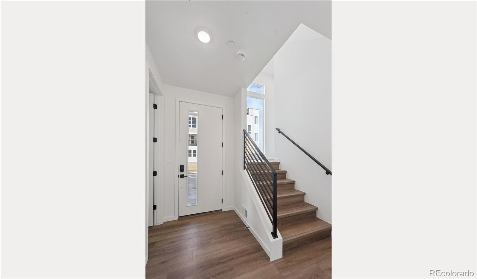 1227 Rhett Drive Erie, CO 80026 - Photo 2 of 24 a view of entryway with stairs and wooden floor