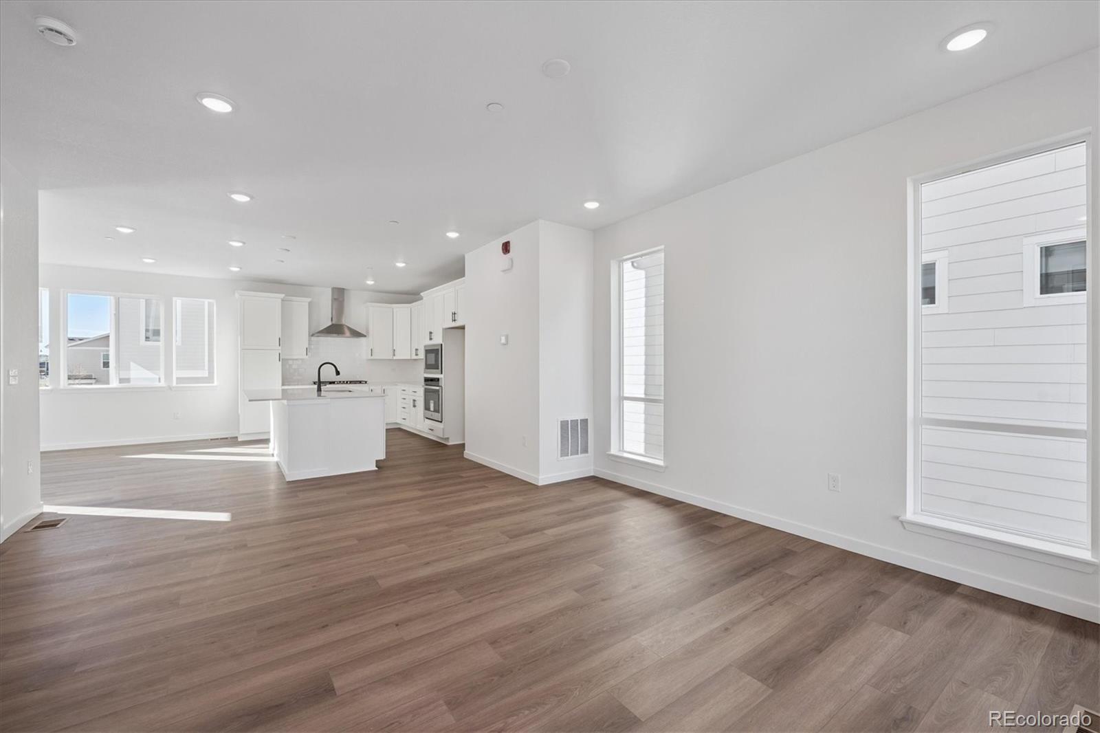 1227 Rhett Drive Erie, CO 80026 - Photo 7 of 24 a view of kitchen with wooden floor and window