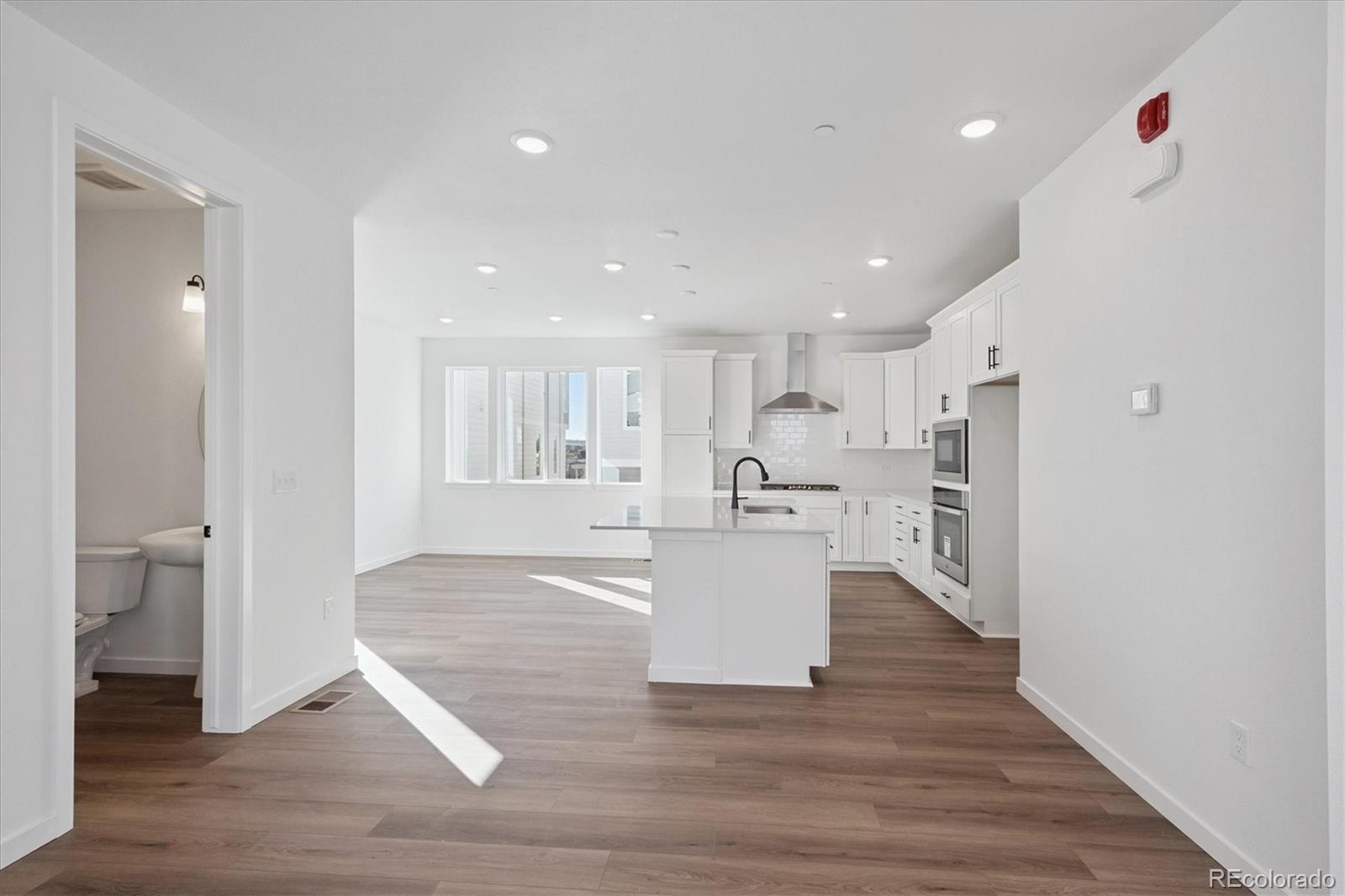 1227 Rhett Drive Erie, CO 80026 - Photo 8 of 24 a view of kitchen with furniture and wooden floor