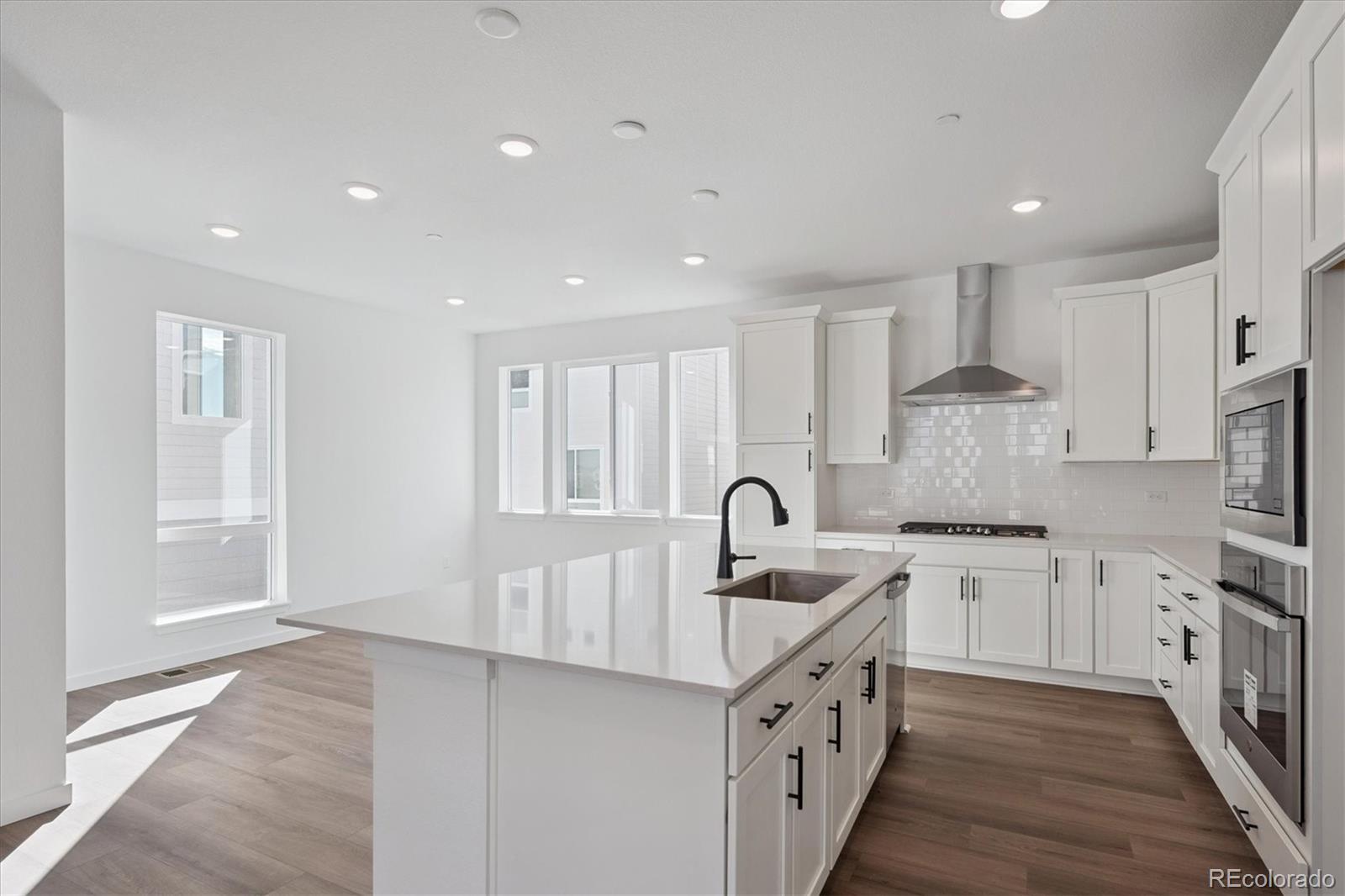 1227 Rhett Drive Erie, CO 80026 - Photo 10 of 24 a kitchen with white cabinets appliances and sink