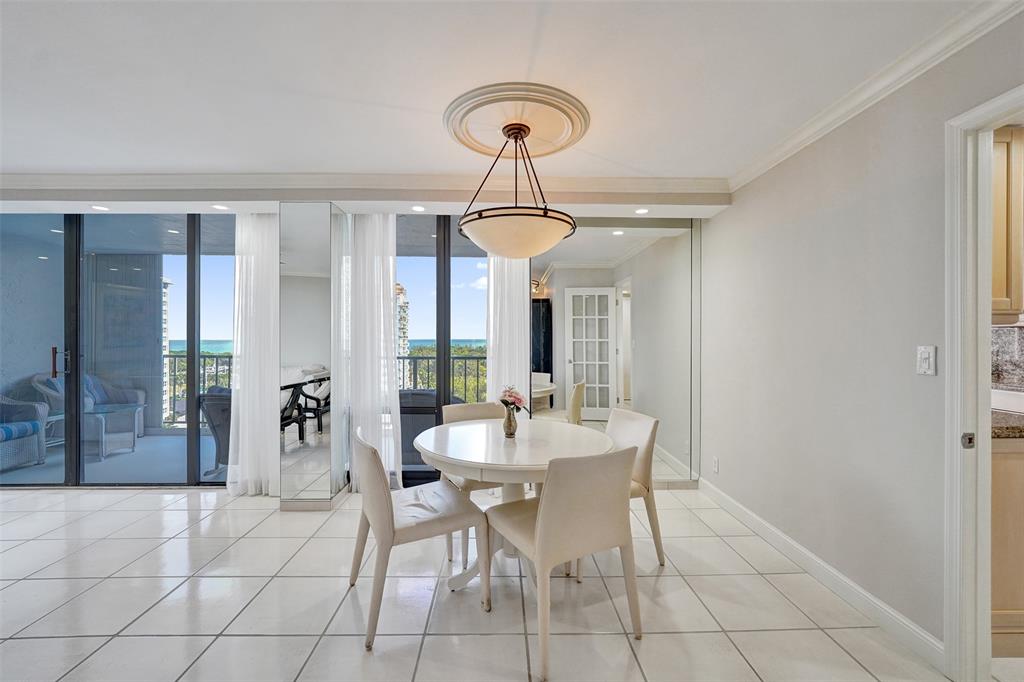 936 Intracoastal Drive, Unit 12C Fort Lauderdale, FL 33304 - Photo 16 of 65 a dining room with chandelier fan and glass door