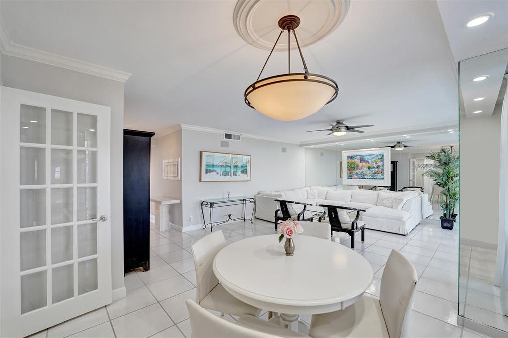 936 Intracoastal Drive, Unit 12C Fort Lauderdale, FL 33304 - Photo 17 of 65 a living room with a couch and a chandelier