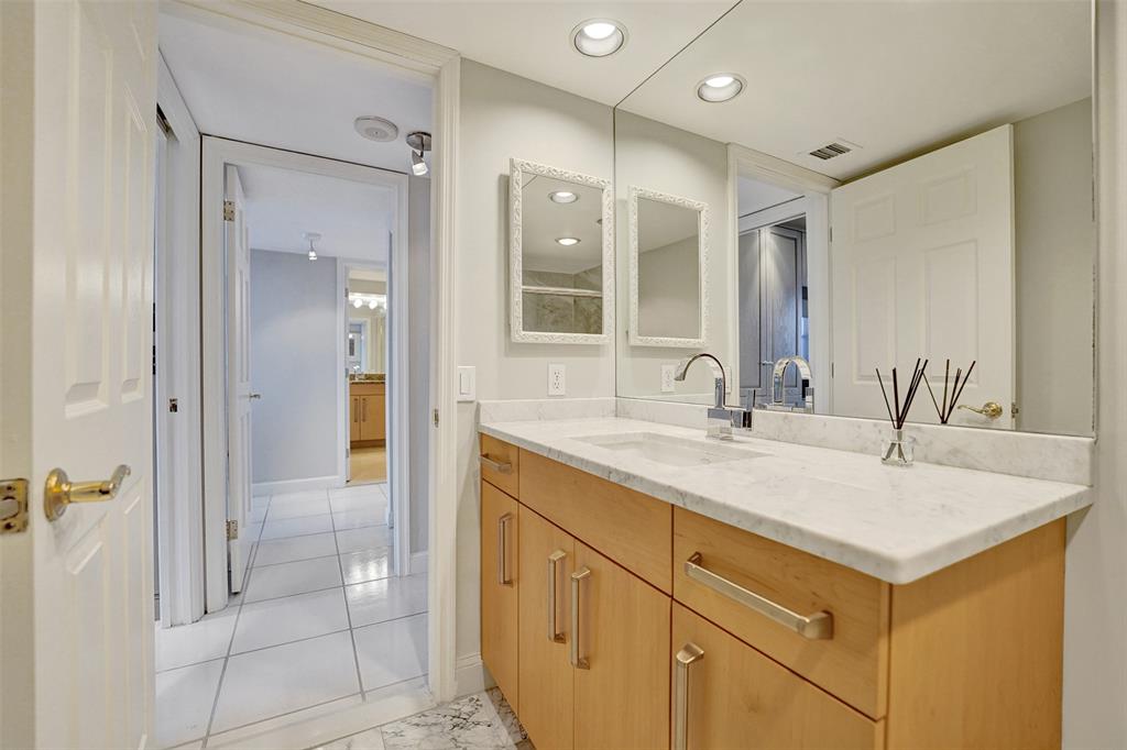 936 Intracoastal Drive, Unit 12C Fort Lauderdale, FL 33304 - Photo 18 of 65 a bathroom with a shower sink and mirror