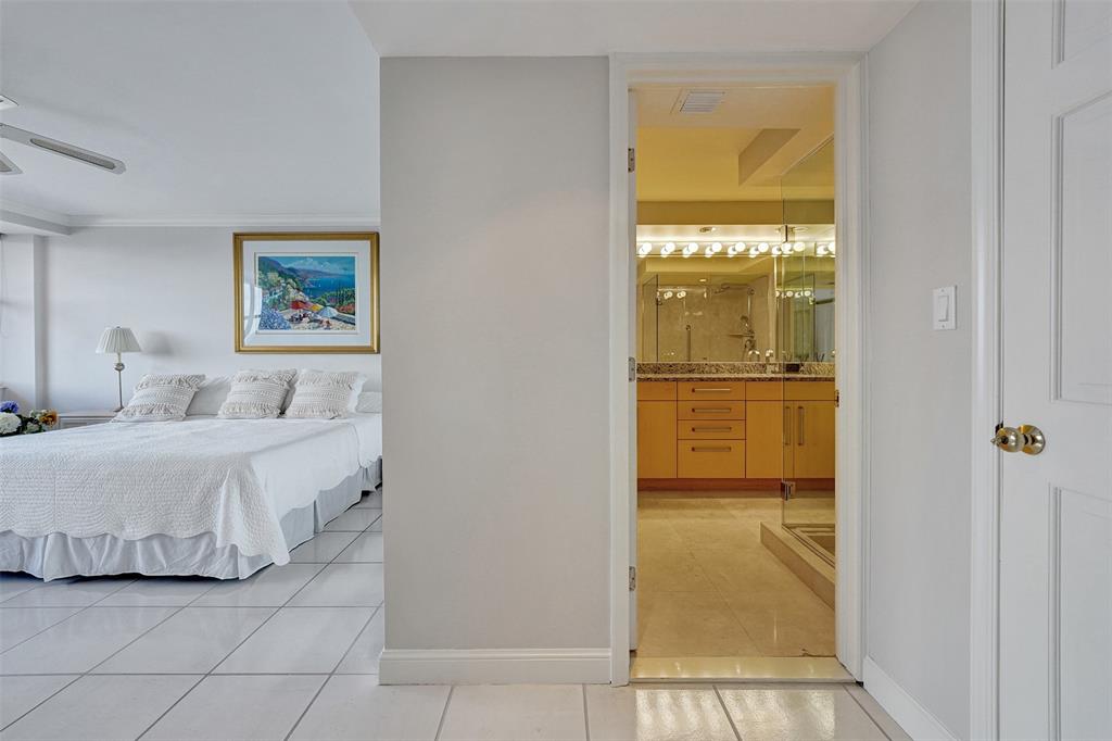 936 Intracoastal Drive, Unit 12C Fort Lauderdale, FL 33304 - Photo 25 of 65 a bedroom with a bed and a painting on the wall