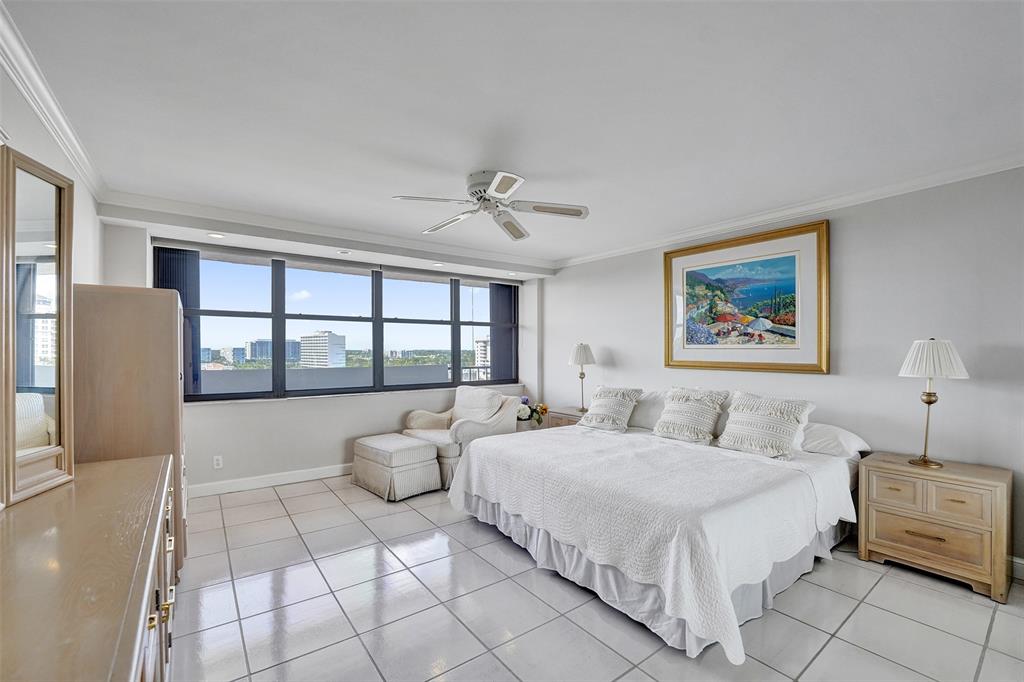 936 Intracoastal Drive, Unit 12C Fort Lauderdale, FL 33304 - Photo 26 of 65 a spacious bedroom with a bed a couch and a window