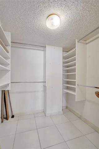 a kitchen with granite countertop white cabinets and sink