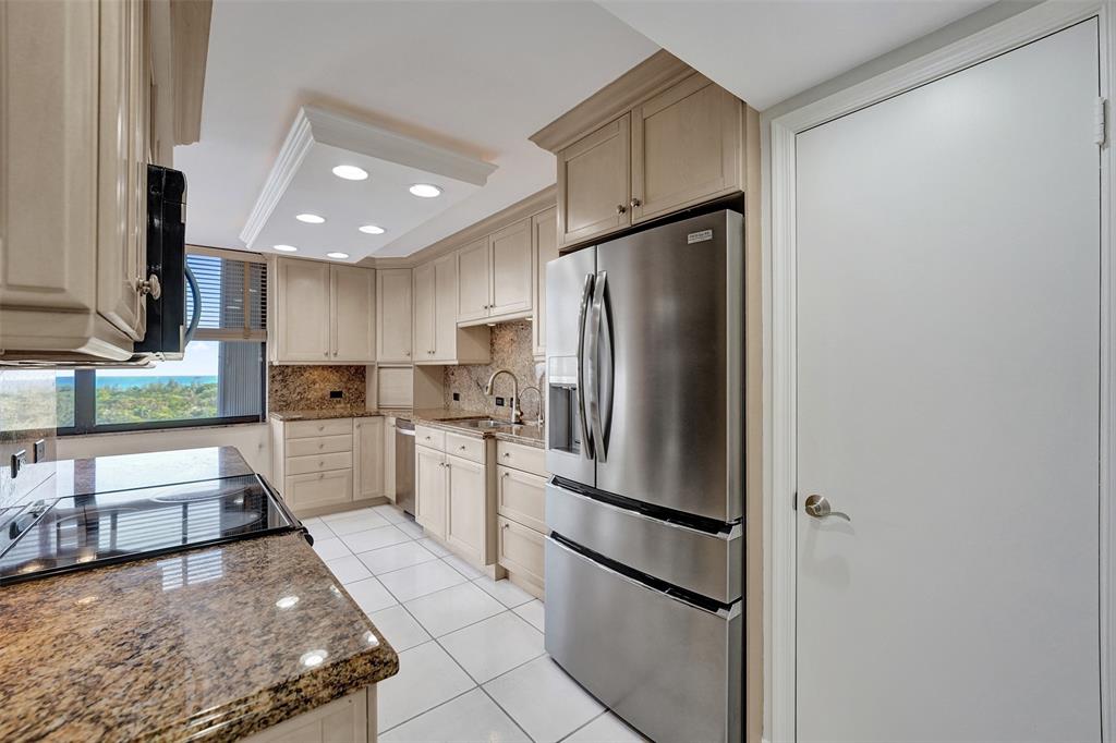 936 Intracoastal Drive, Unit 12C Fort Lauderdale, FL 33304 - Photo 35 of 65 a kitchen with stainless steel appliances granite countertop a refrigerator a stove and a sink