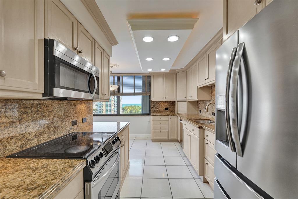 936 Intracoastal Drive, Unit 12C Fort Lauderdale, FL 33304 - Photo 37 of 65 a kitchen with stainless steel appliances granite countertop a sink stove and refrigerator